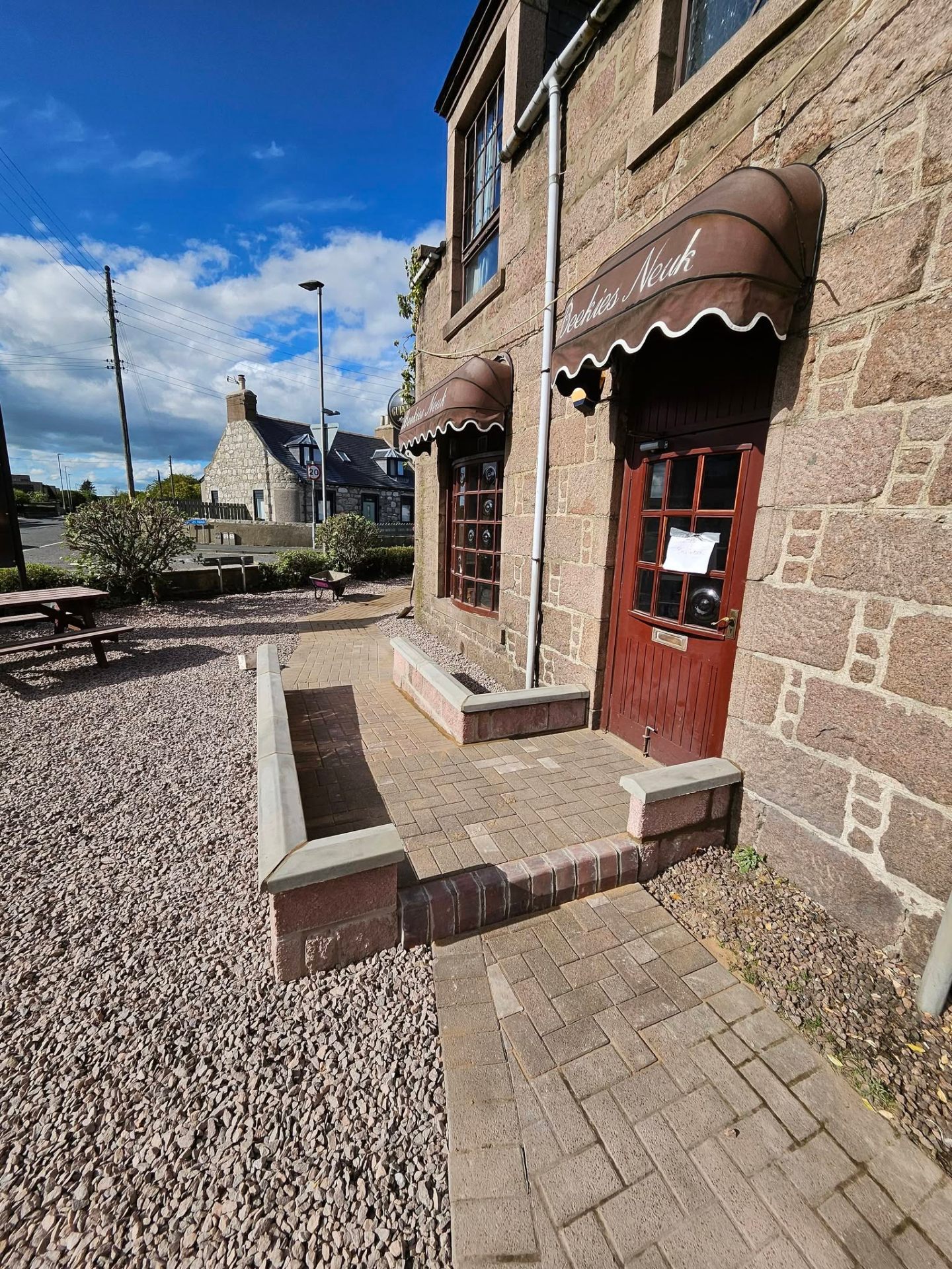 Block-paved entrance and steps at a stone building