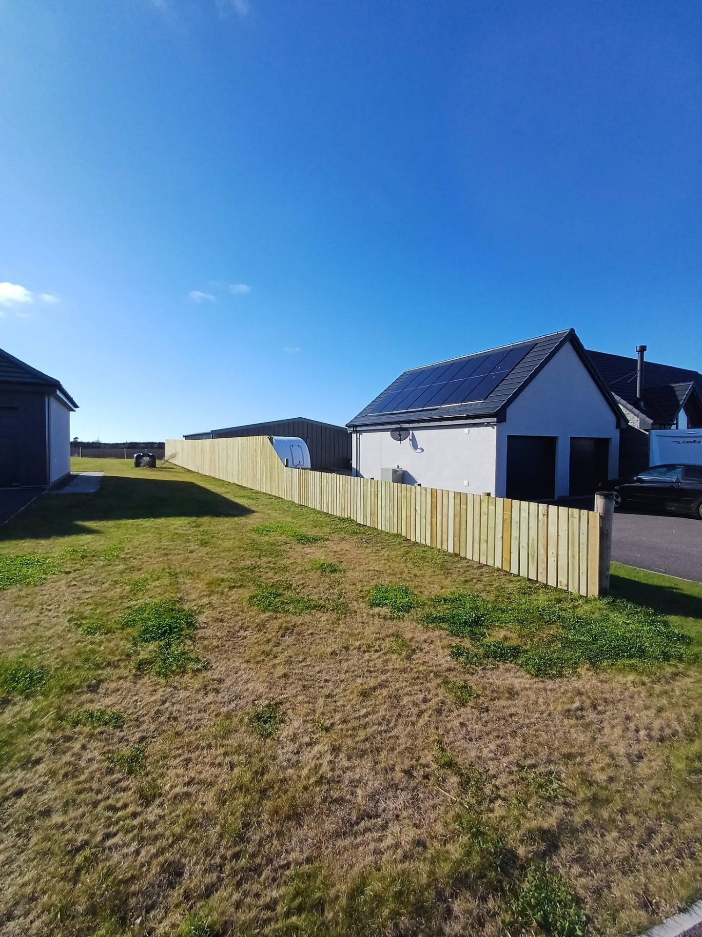 New timber fence line along a garden boundary